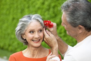 elevated view of a husband placing a flower in his wife's hair